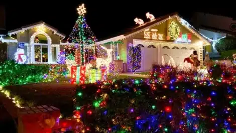 Exterior of a home covered in Christmas lights.
