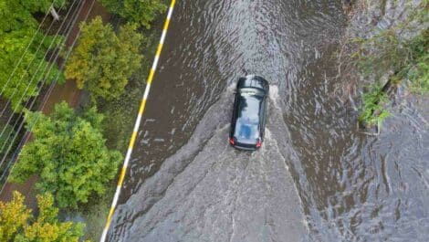a car driving through a shallow flood