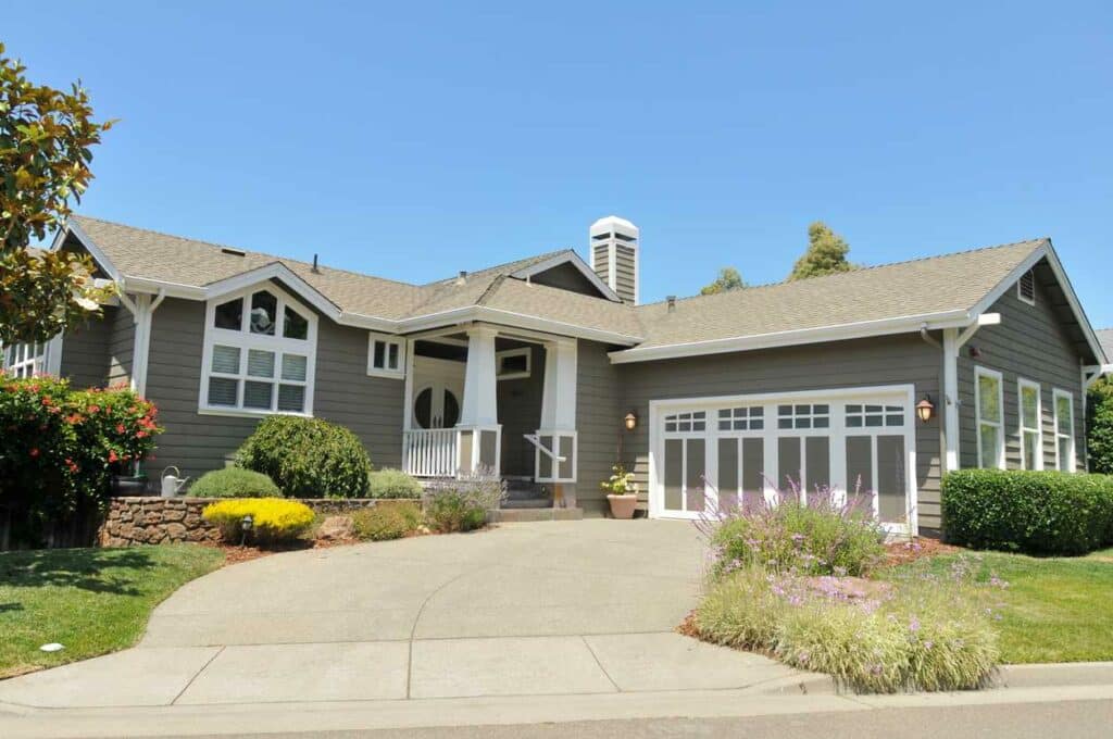 A single-story gray house on a sunny day