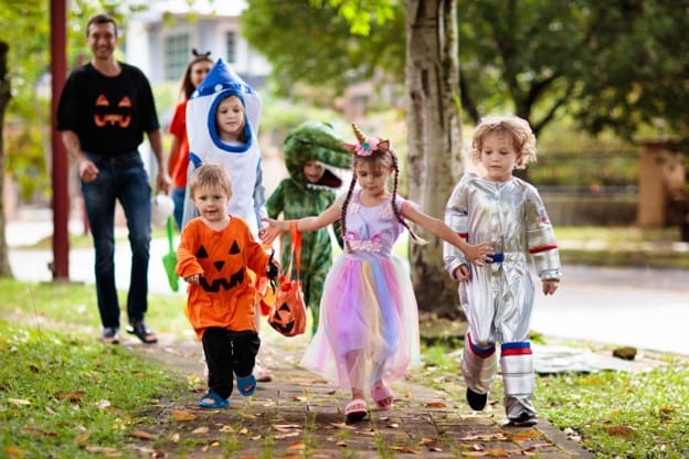 Kids dressed up for Halloween on a trick or treat.