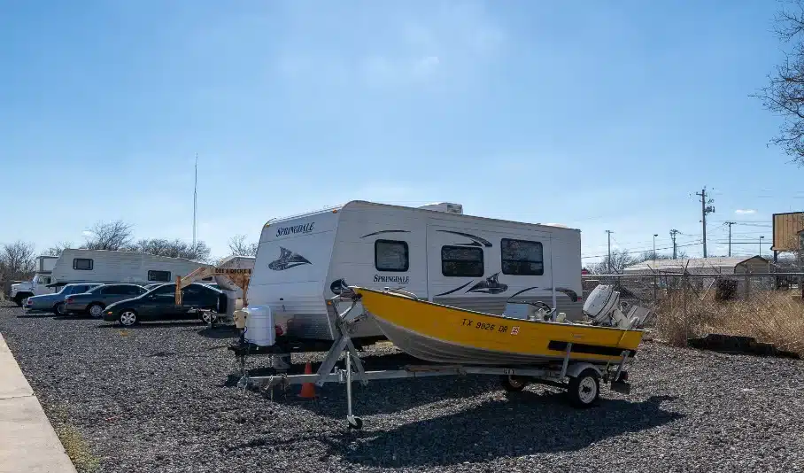 Photo of RV's and boats in open parking.